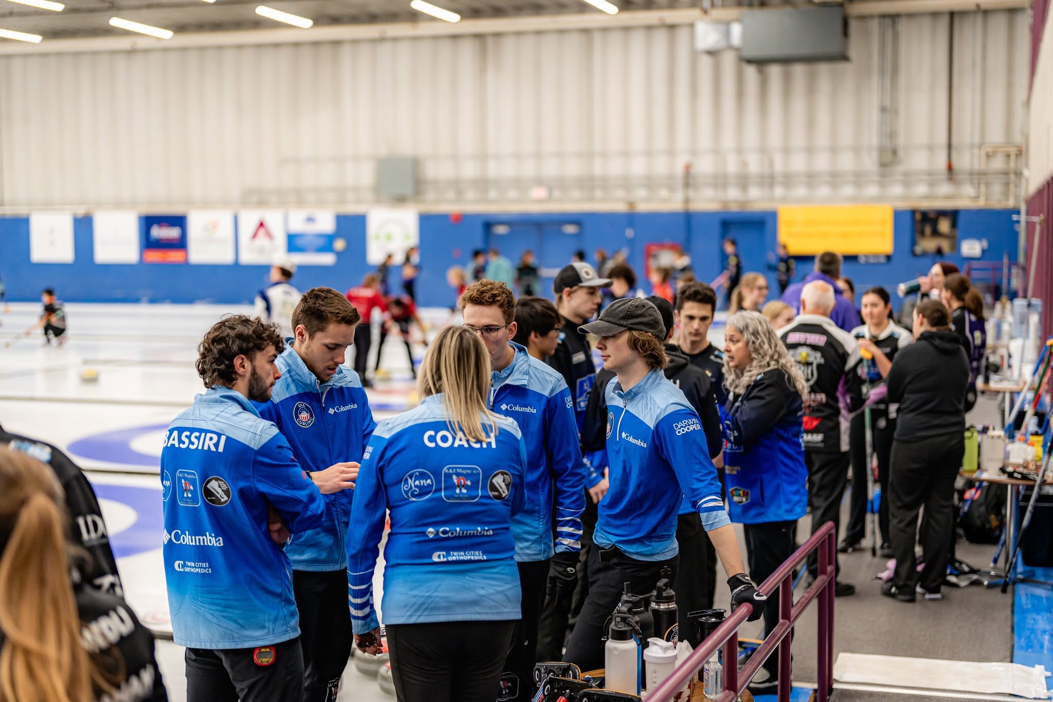 Junior teams and coaches gathered beside the ice between games